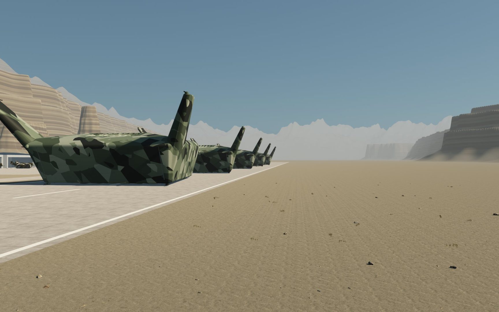 Several large camouflaged landing barges with tall raised corner fins stand in a row along a sandy airfield under a blue sky, cliffs in the distance.